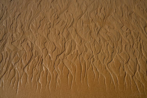 Tidal sand patterns at low tide, Trancoso — photograph by Lawrence Leyderman