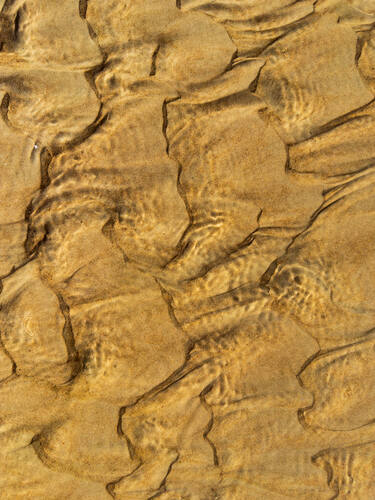 Tidal sand patterns at low tide, Trancoso — photograph by Lawrence Leyderman