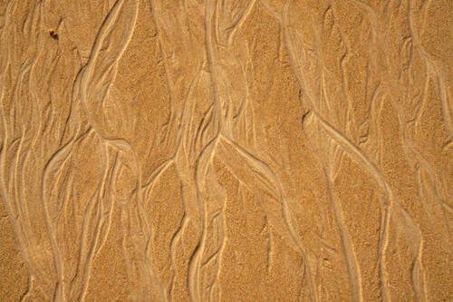 Tidal sand patterns at low tide, Trancoso — photograph by Lawrence Leyderman