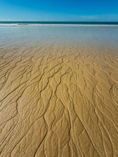 Tidal sand patterns at low tide, Trancoso — photograph by Lawrence Leyderman