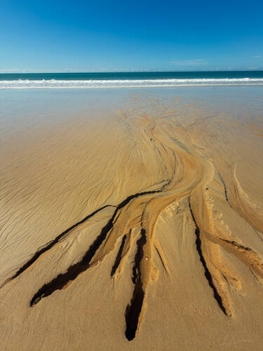 Tidal sand patterns at low tide, Trancoso — photograph by Lawrence Leyderman