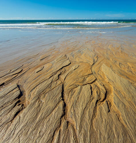 Tidal sand patterns at low tide, Trancoso — photograph by Lawrence Leyderman